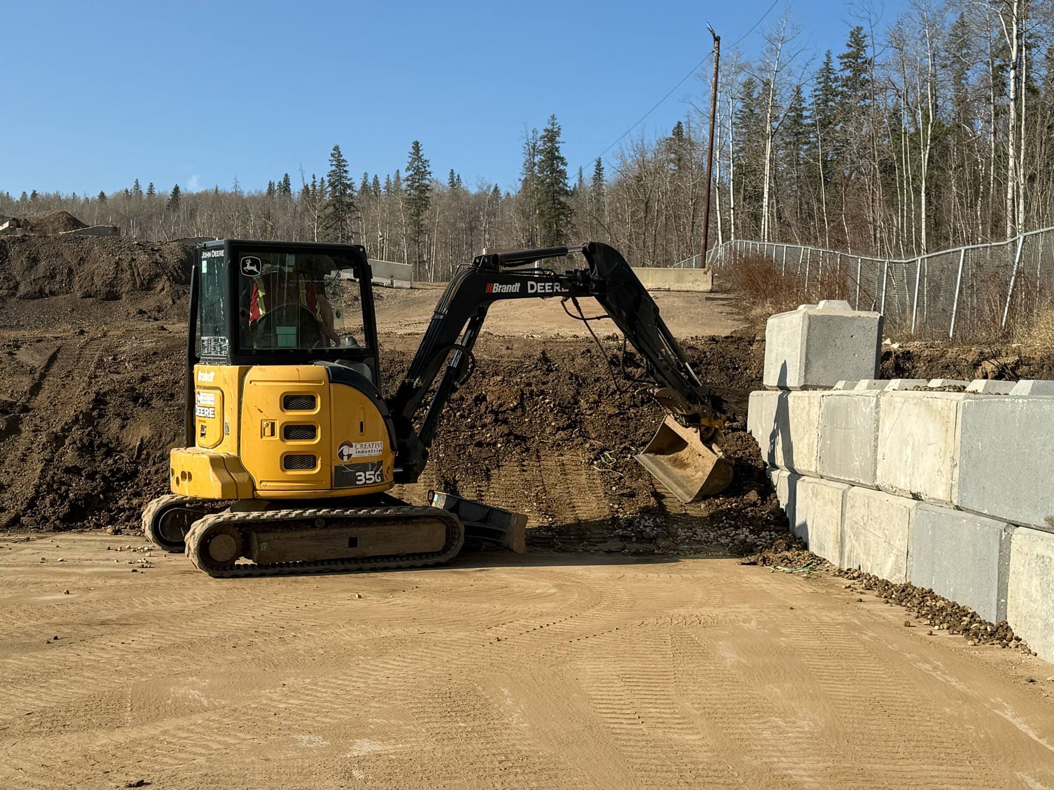 Retaining wall construction with mini excavator